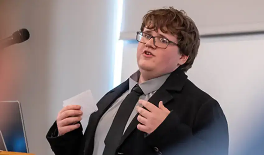 New Visions student and future SUNY Oneonta Red Dragon, Zebb Henness, presenting at the symposium