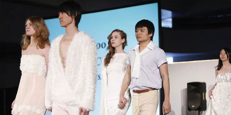 Students modeling clothes made by fashion students.
