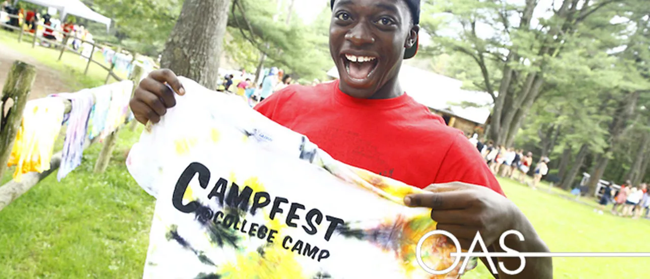 Student holding Campfest t-shirt