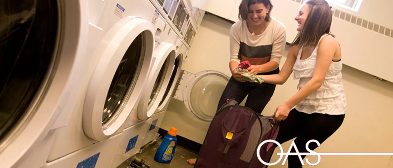Two students enjoying doing laundry together