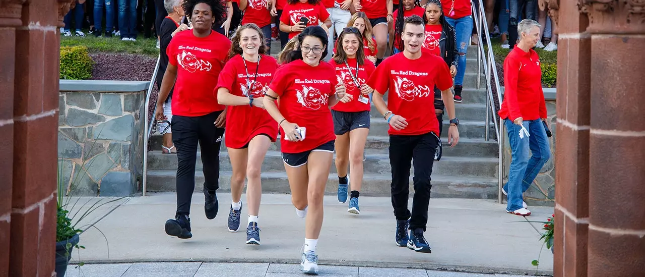 Students running between Old Main pillars