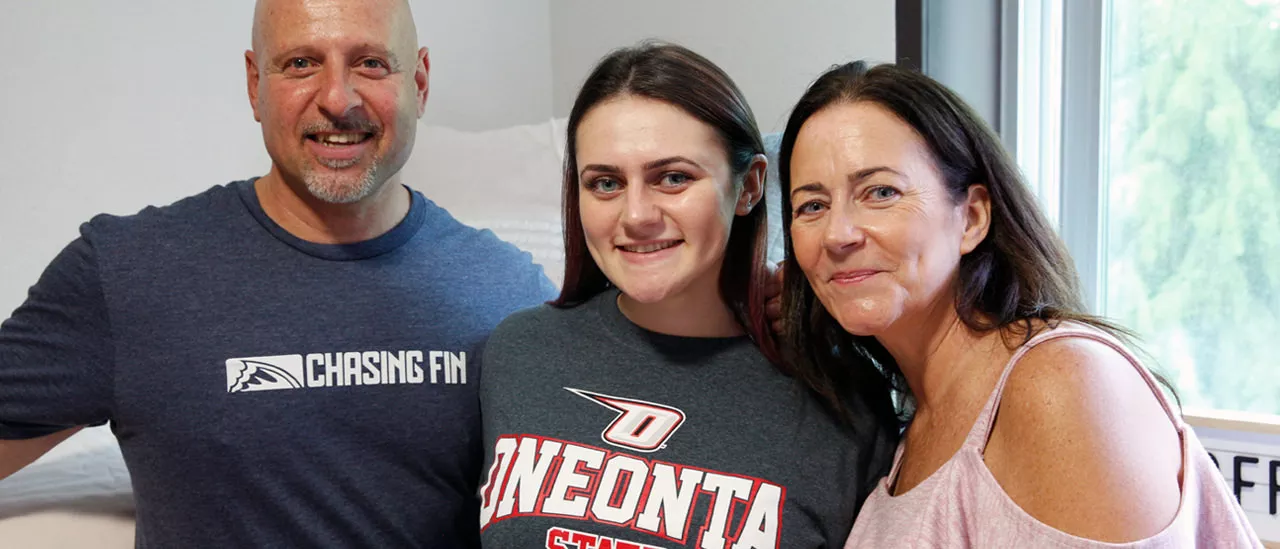 Mother and father helping their daughter move into her new dorm.