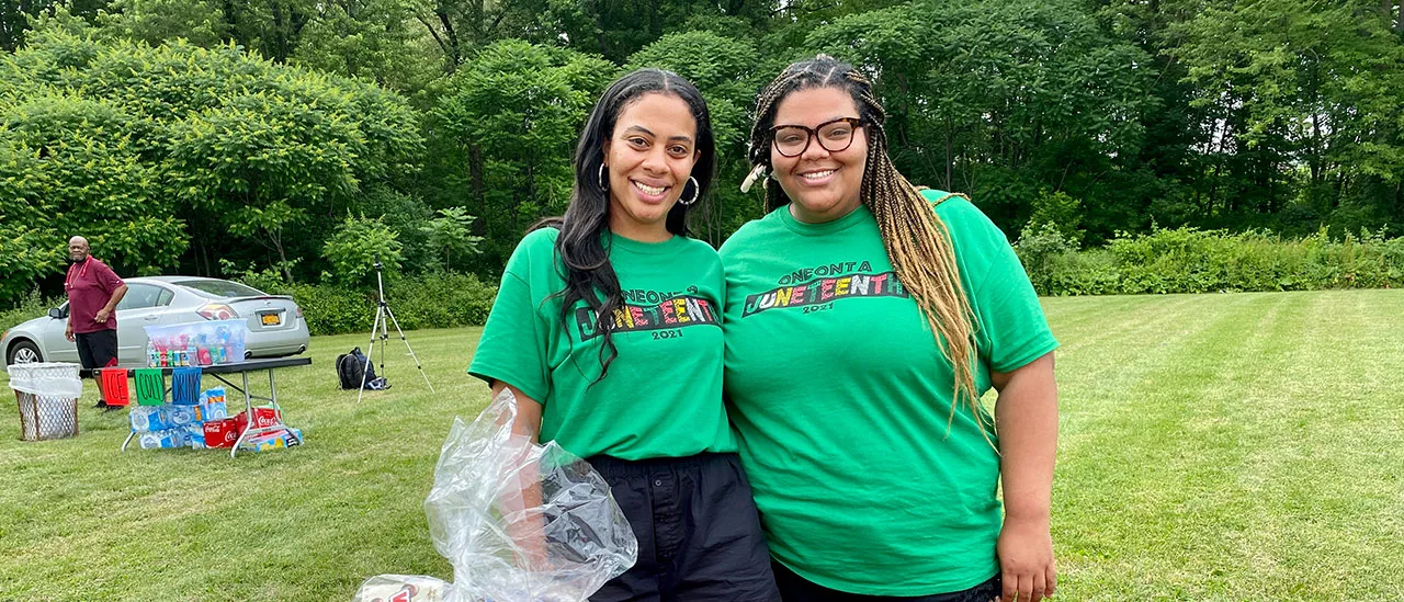 Sierra Sangetti-Daniels, left, and her sister, event creator Diandra Sangetti-Daniels, stand near the raffle basket table during the Juneteenth event.