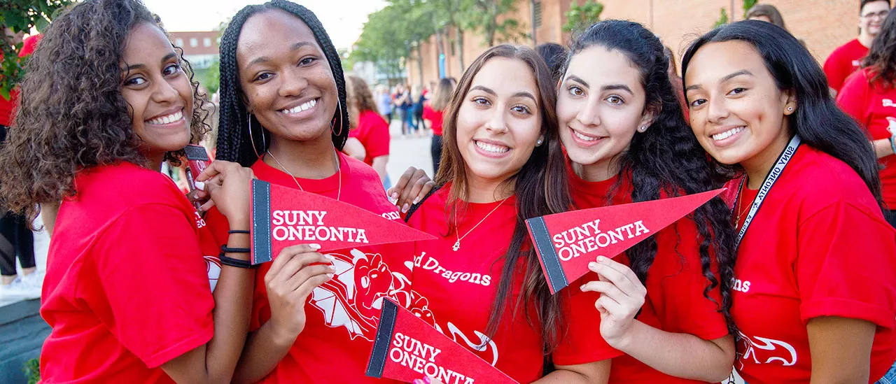 Students Holding SUNY Oneonta Pennet