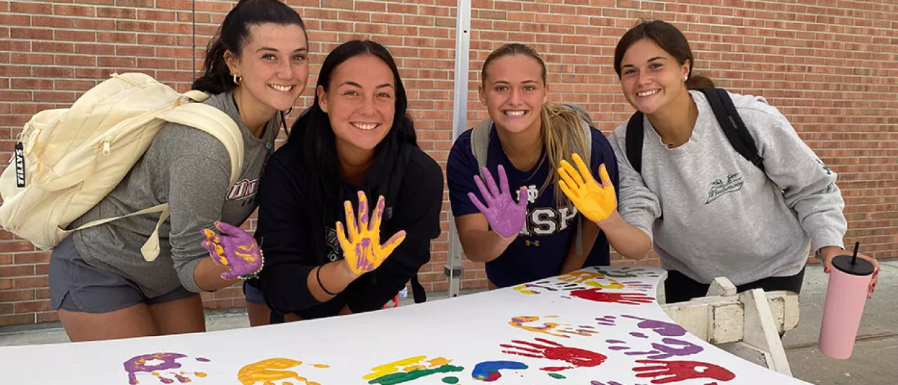 Students Place Painted Hand Prints on the WIngs