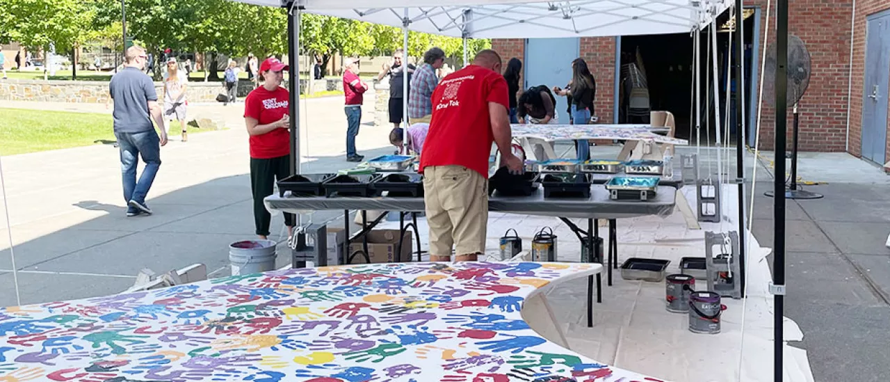 Students Place Painted Hand Prints on the WIngs