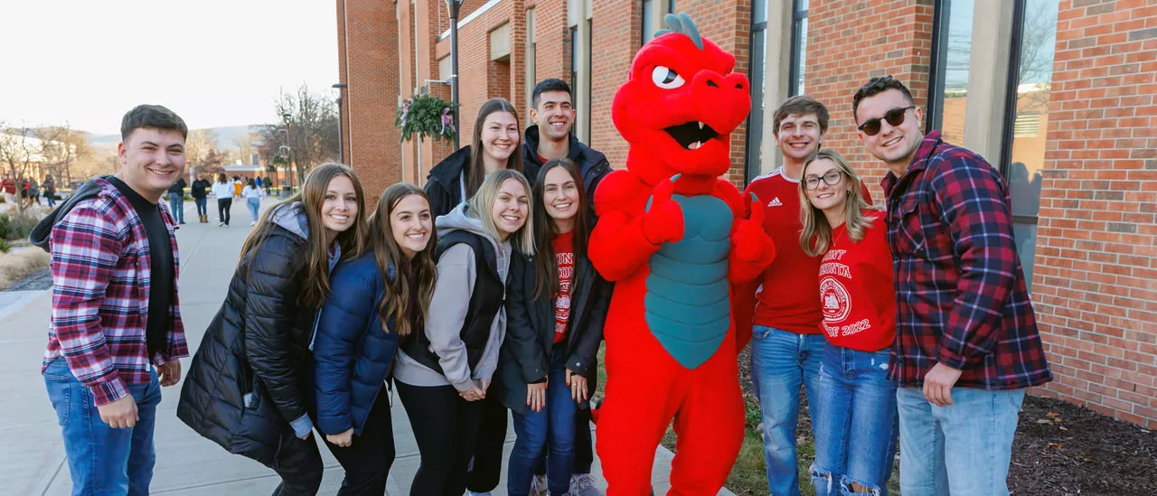 Students taking a picture with Red the Dragon