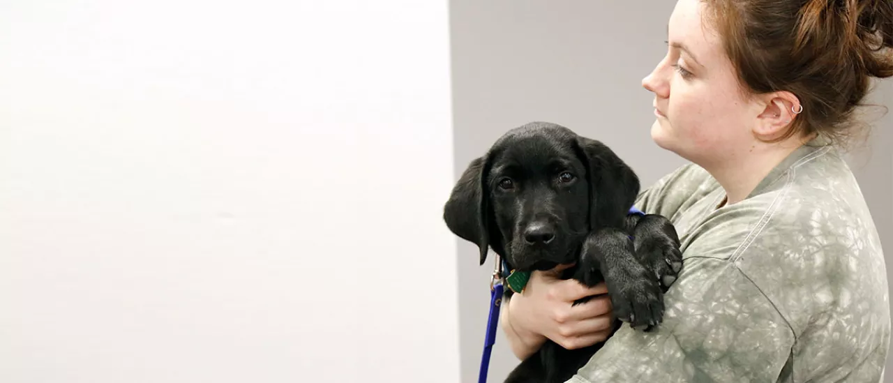 Student holding Puppy