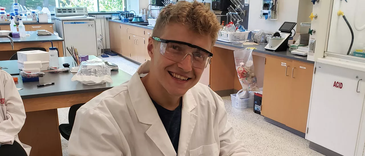 Chemistry major Jacob Aubrey prepares media to grow bacteria for this year's project.