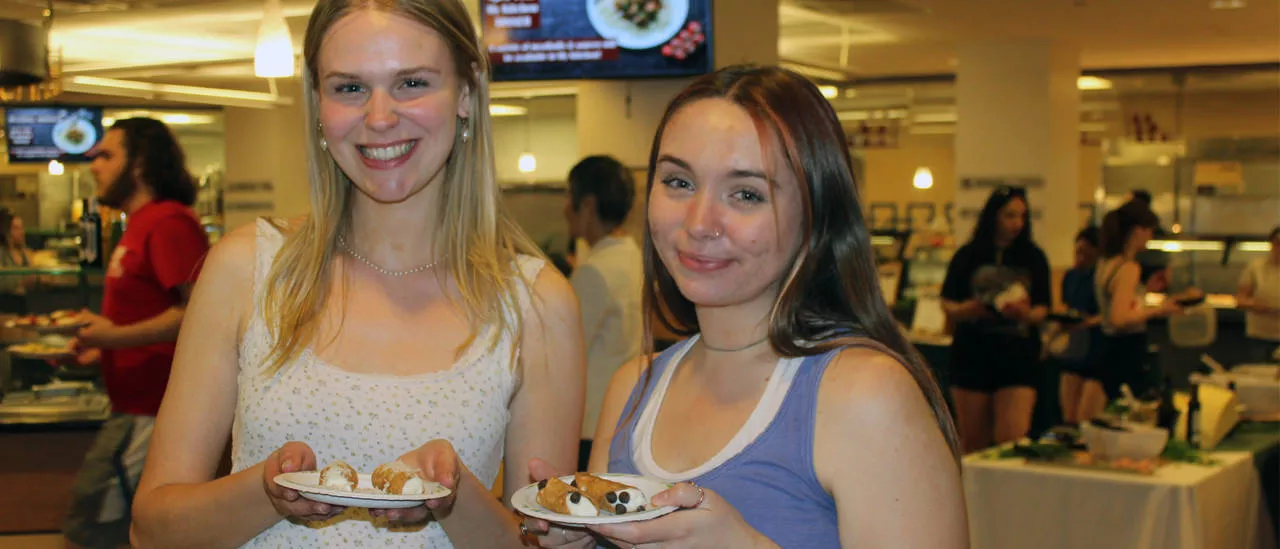 Two Students showing their food.