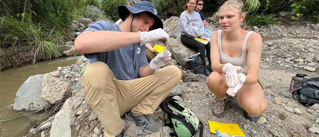 Guatemala trip students looking at river samples