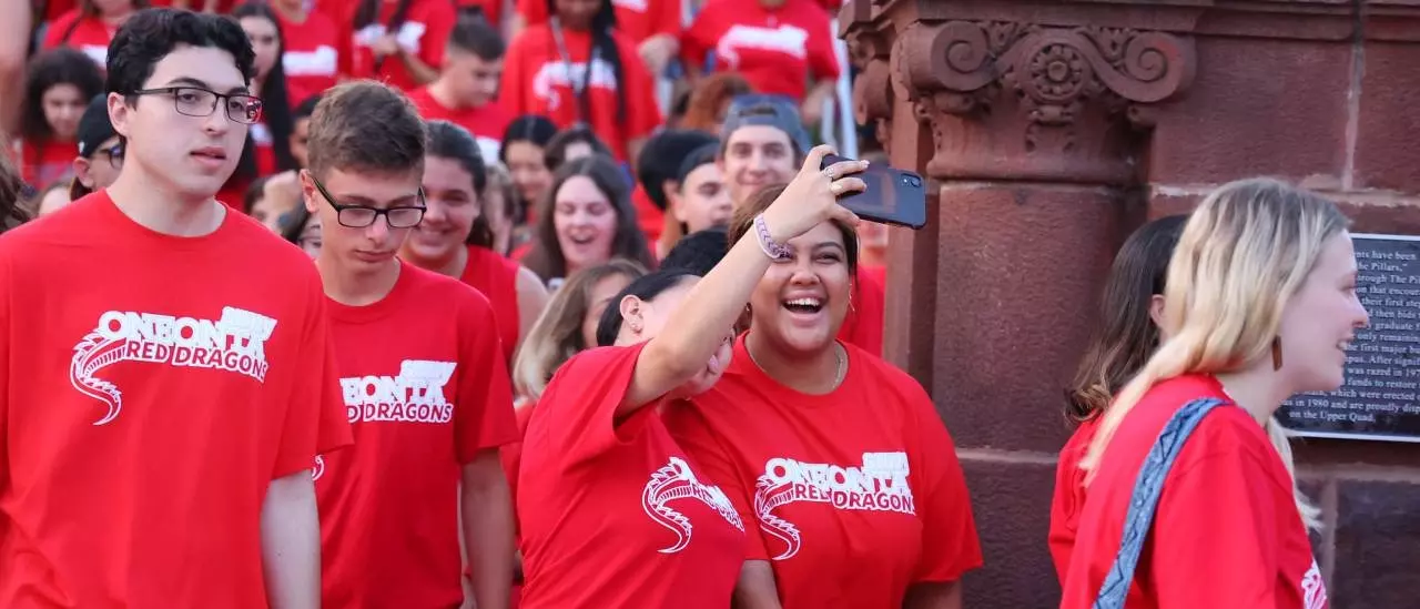 Two students smiling while taking a selfie together at the Pass Through the Pillars event.