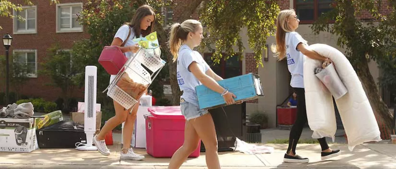 Students carrying goods on move in day.