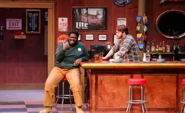 Students perform on stage in a production of live theatre