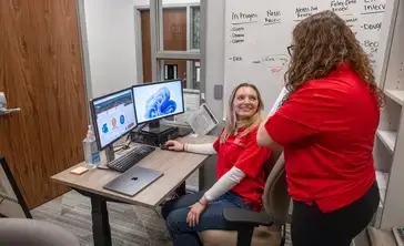 Volunteers discuss income tax assistance