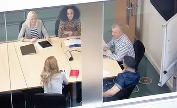 High angle view of businessmen and women having meeting at conference table