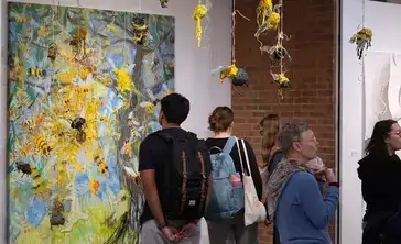 A large abstract painting is studied