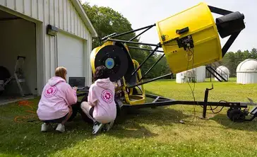 STEM students work with a telescope at the observatory.