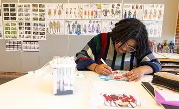 A student works on sketches during an illustration class.