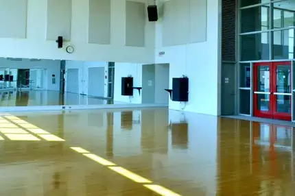 Dance studio in the Alumni Field House with mirrored walls and hardwood floors.