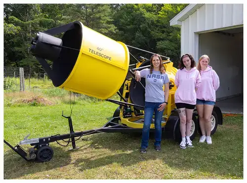 Students with Valerie Rapson standing by telecope