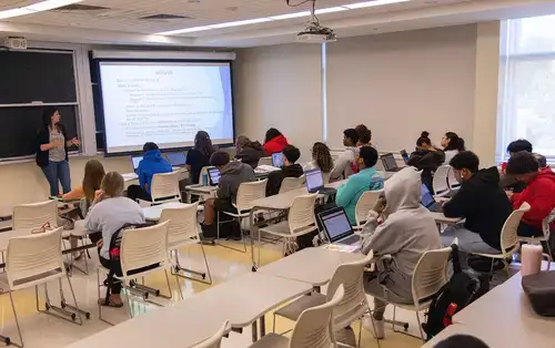 Summer Academy Students listen to lesson from instructor