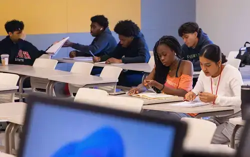 Summer Academy Students take notes in class