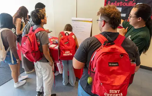 Students from Summer Academy and the backpacks they received.