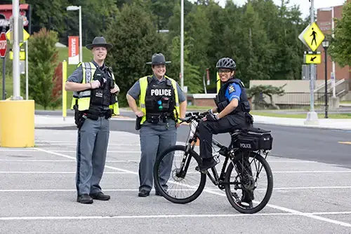 Three Police officers during Move-In - two officers are on foot and one is on a bicycle