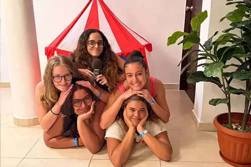 podcast crew pose for photo in pyramid pattern