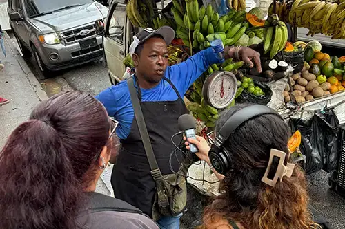 Students interview local banana street vendor
