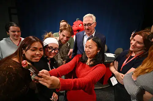 Red and Sal take selfie with students