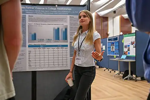 Student explains their research to another student