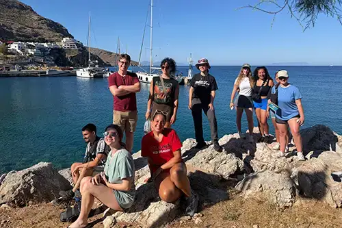 Greece FL Trip Students pose near ocean