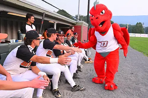 Red give high fives to the oneonta outlaws team