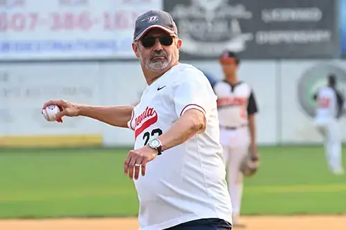 Dr Cardelle throws the first pitch of the game