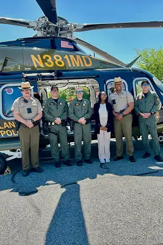 Ari Boyd poses with helicopter and Maryland state police