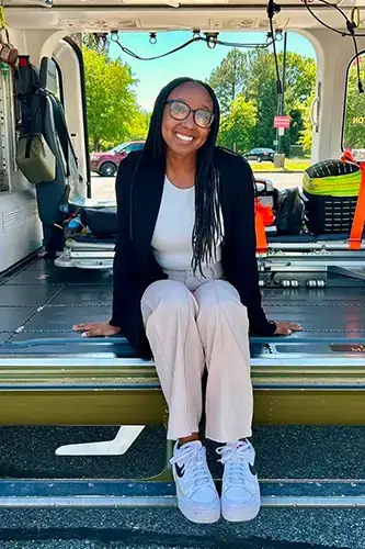 Ari Boyd poses in Maryland state police car
