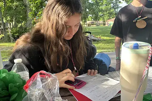 intern working at picnic table
