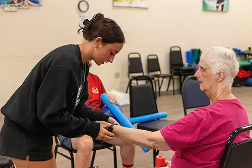 Exercise Students at The Gathering Place in east Oneonta check heart rate of resident