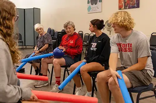 Exercise Students at The Gathering Place in east Oneonta play fun game with residents
