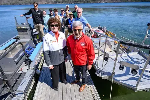 Dr. Cardelle poses with students and faculty on a dock at the Biological Field Station.