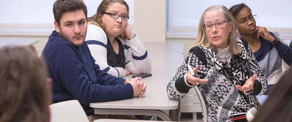 photos of professor and students in classroom. 