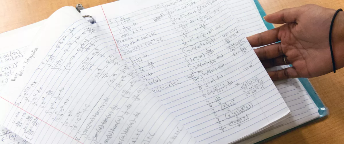 Math equations in a student's notebook.