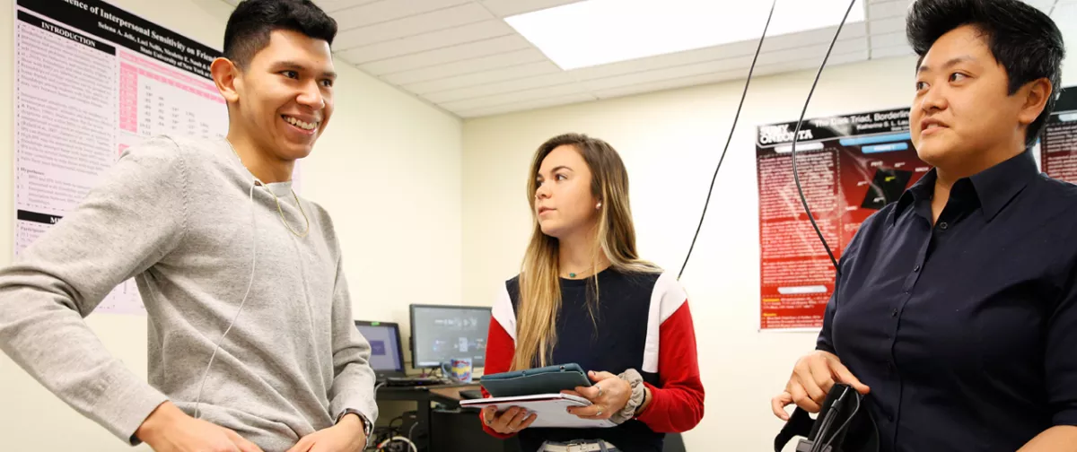 Professor Lau helping students set up a virtual reality research project.