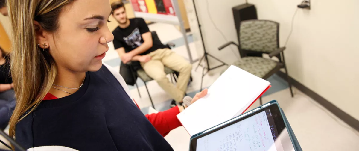 Student using a tablet to take notes.