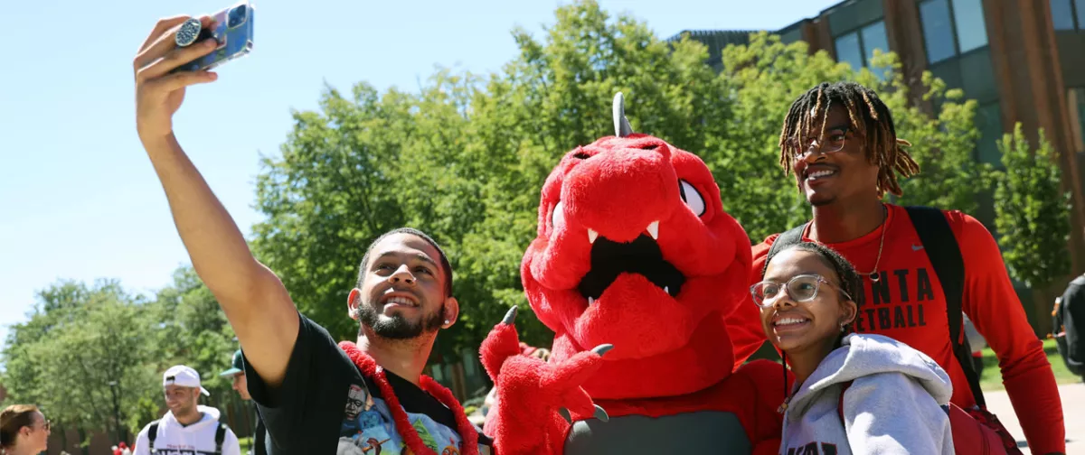 Students taking a selfie with Red the Dragon