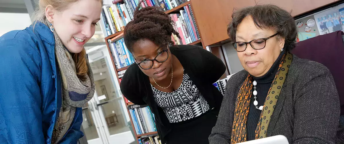 Cooperstown Graduate Program faculty and students in an office