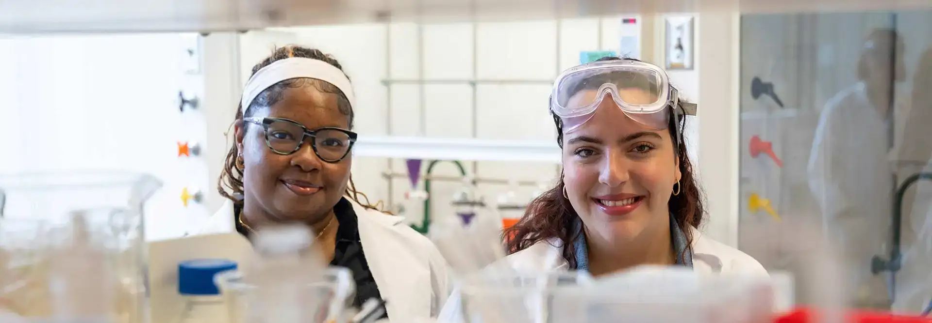 Two students posing for a photo in a chemistry lab.