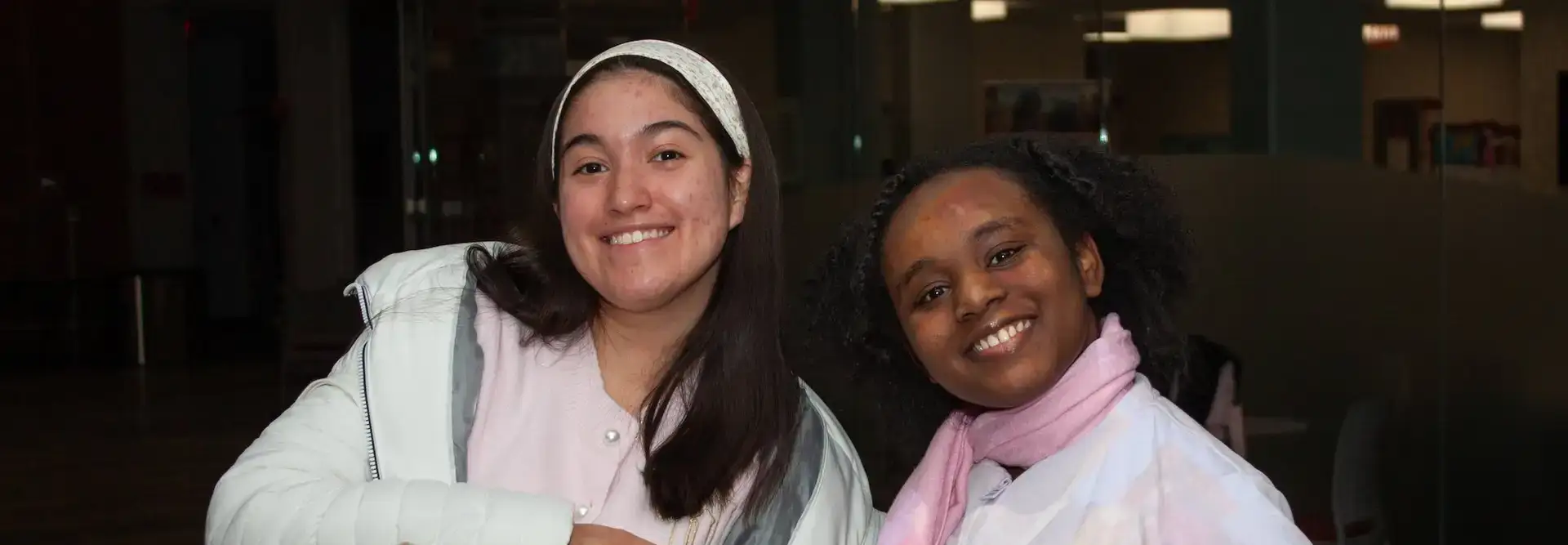 Two smiling students posing for a photo together